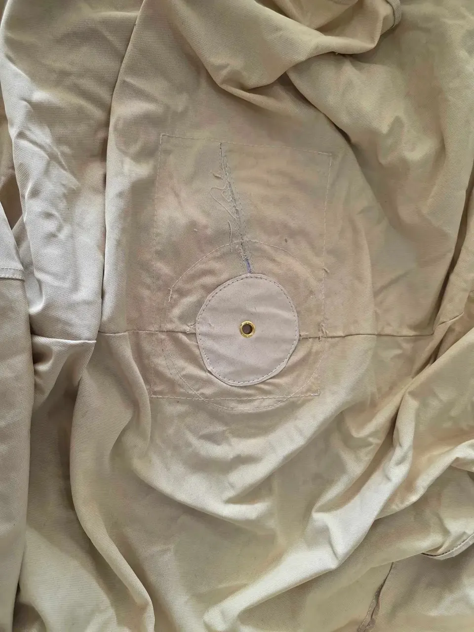 Before the repair: Canvas Umbrella Cover — Center Pole Grommet Repair